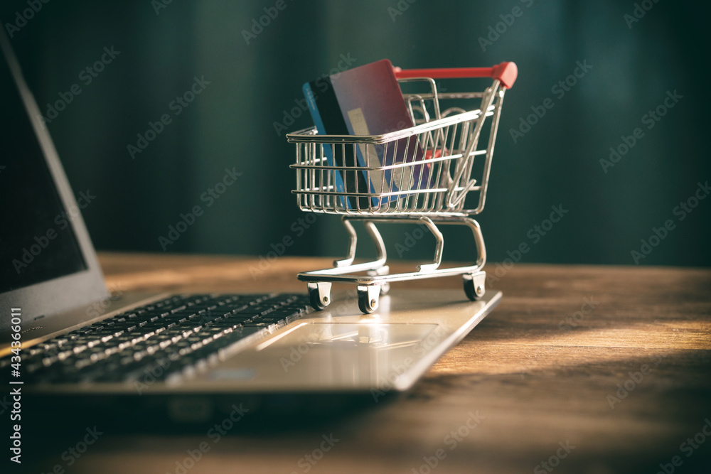 Small shopping cart on laptop computer online payment shopping concept credit card ecommerce home delivery