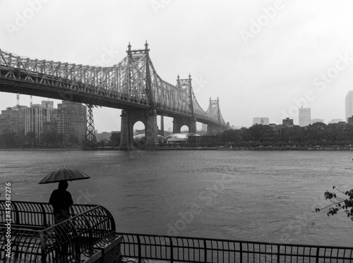 Alone on a rainy day at Sutton Place Park with a view of the Queensboro Bridge and the East River photo