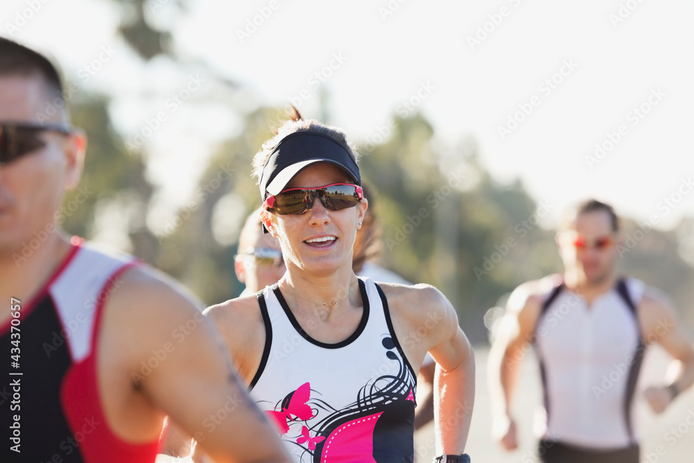 Female athlete with competitors running in race StockFoto Adobe Stock