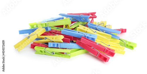 Many colorful plastic clothespins on white background