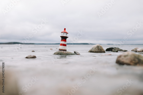 Sea with decorative lighthouse. Nautical lifestyle. Winter, Sea, Travel, adventure, holidays and vacation concept. Travel in 2021