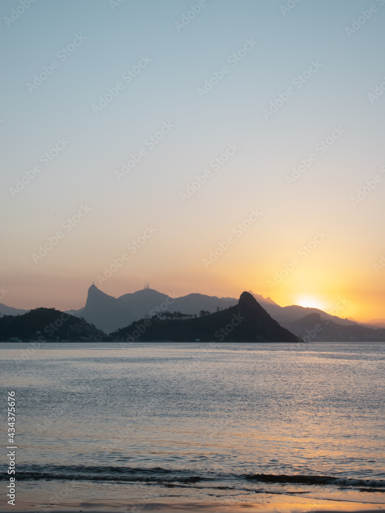Sunset in the sea and, mountains - vertical