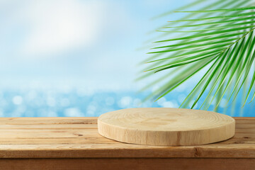 Empty wooden log on rustic table over blurred sea beach background.  Summer mock up for design and product display.