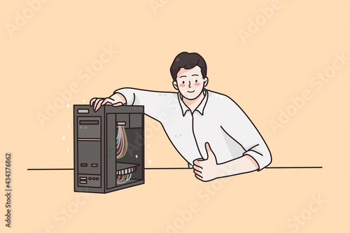 Soft engineering and technologies concept. Young smiling man worker engineer cartoon character sitting with system unit with wires in office and showing thumbs up sign with finger 