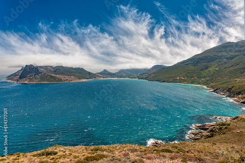 panaramic view on Hout Bay, the southern Harbor of Cape Town, with characteristic table cloth clouds rolling over the mountains,South Africa, landscape 