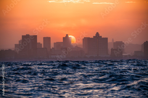 Approaching Durban from sea at sunset with big waves on the Indian Ocean, South Africa © Uwe