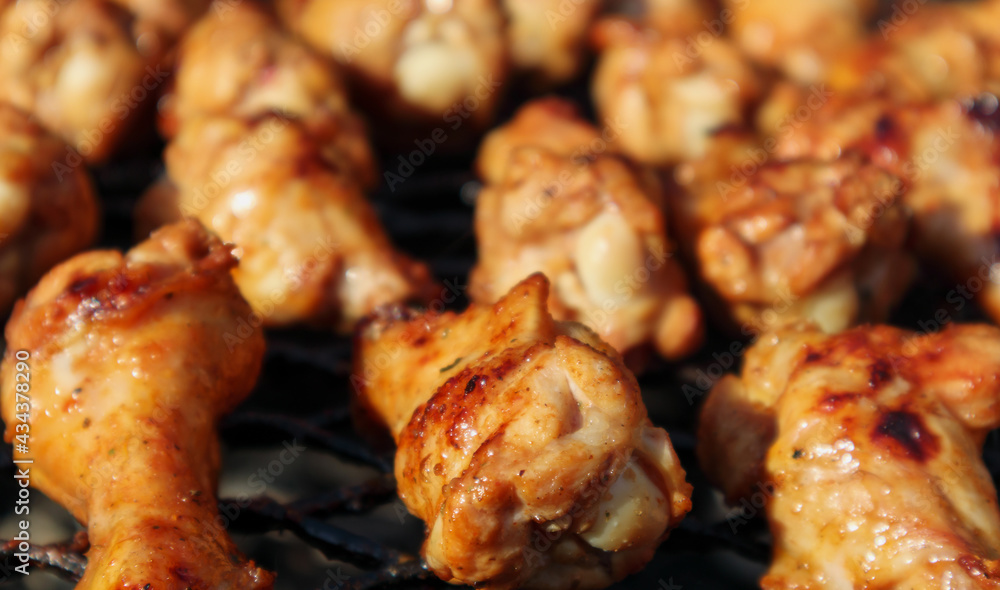 Fried chicken wings on a grill close - up. Soft focus
