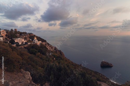 A view of monastery on the cape Fiolent aganst sunset sky and sea