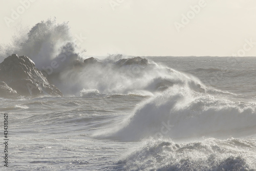 Wave breaking over sea rocks
