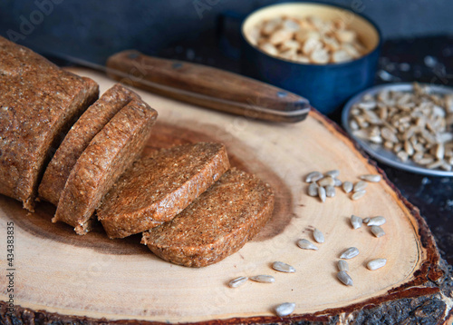 Homemade sunflower halva sliced on wooden background