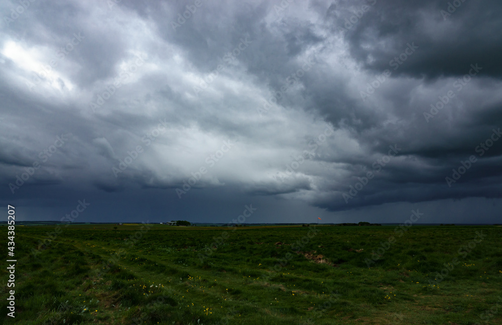 with sheet rain in the distance, heavy dark storm clouds gather over an airfield on Salisbury Palin military training area with sheet rain in the distance, heavy dark storm clouds gather over an airfield on Salisbury Palin military training area