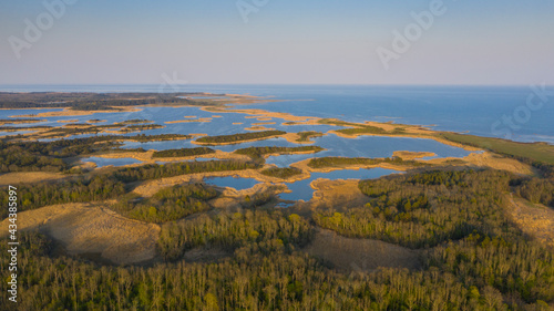 Bild auf Leinwand Aerial view to the amazing sunset colored coastal seascape with the complex lago
