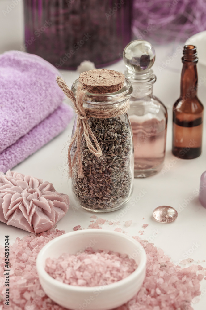 Spa background . Lavender sea salt, lavender soap, towels and bottles of lavender herbs and essential oil on white background. Body care. Spa background . Lavender sea salt, lavender soap, towels and bottles of lavender herbs and essential oil on white background. Body care.