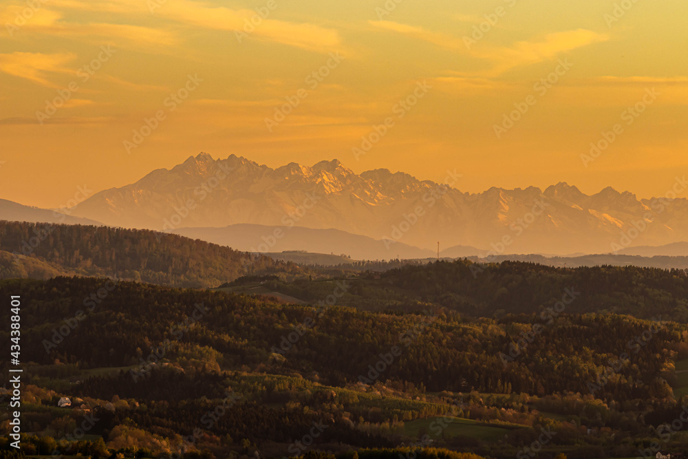 A landscape of mountains and a beautiful sunset.