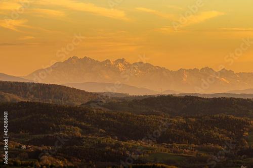 A landscape of mountains and a beautiful sunset.