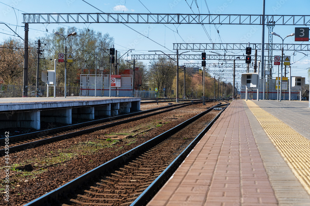 Fototapeta premium Empty railways and railway station, perspective of rails in line, ready for train arriving, railroad infrastructure.