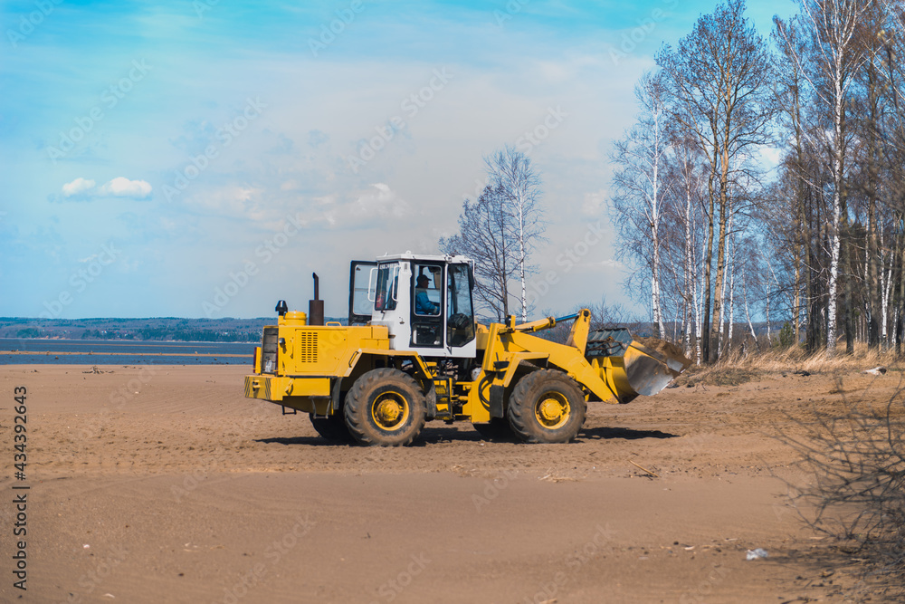 yellow bulldozer work on river coast
