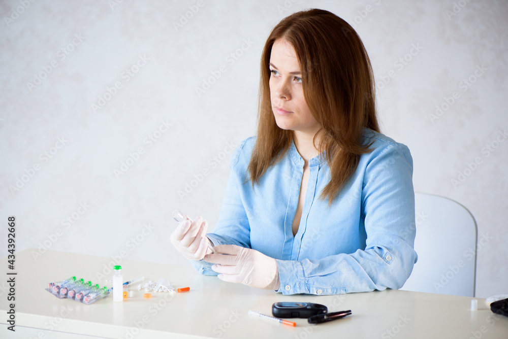 Vials with insulin hormone and single use insulin syringe lying on the table. Set for diabetic Vials with insulin hormone and single use insulin syringe lying on the table. Set for diabetic