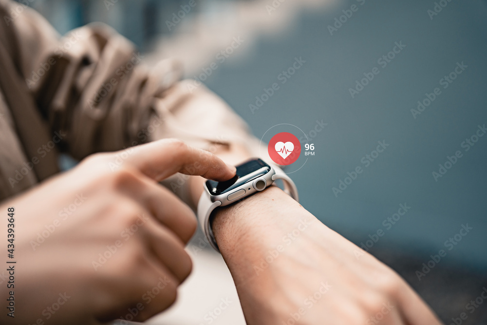 Woman using smart watches with checking pulse via health application. healthcare and people concept. - obrazy, fototapety, plakaty 