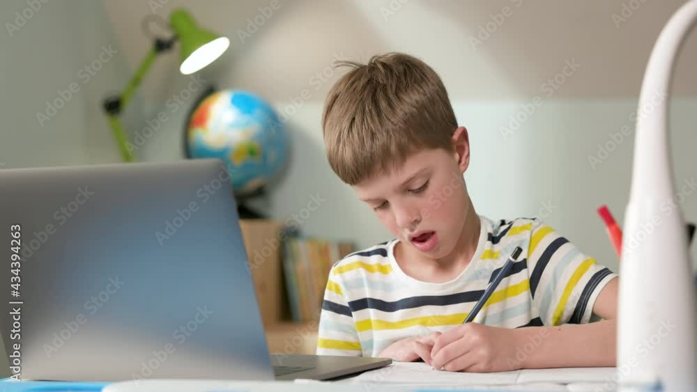 Boy Sitting At Laptop At Home. Cute Seven Year Old Boy Draws. Boy Sitting At Laptop At Home. Cute Seven Year Old Boy Draws.