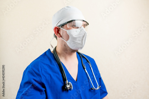 Doctor in blue uniform and medical mask.