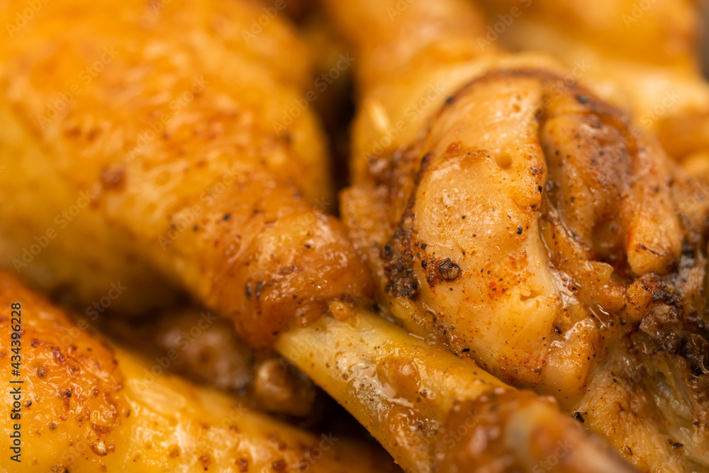 Fried roasted chiken close-up background, chicken legs after grill with golden color