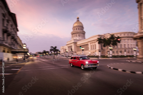 Old car on streets of Havana with Capitolio building in background. Cuba © danmir12