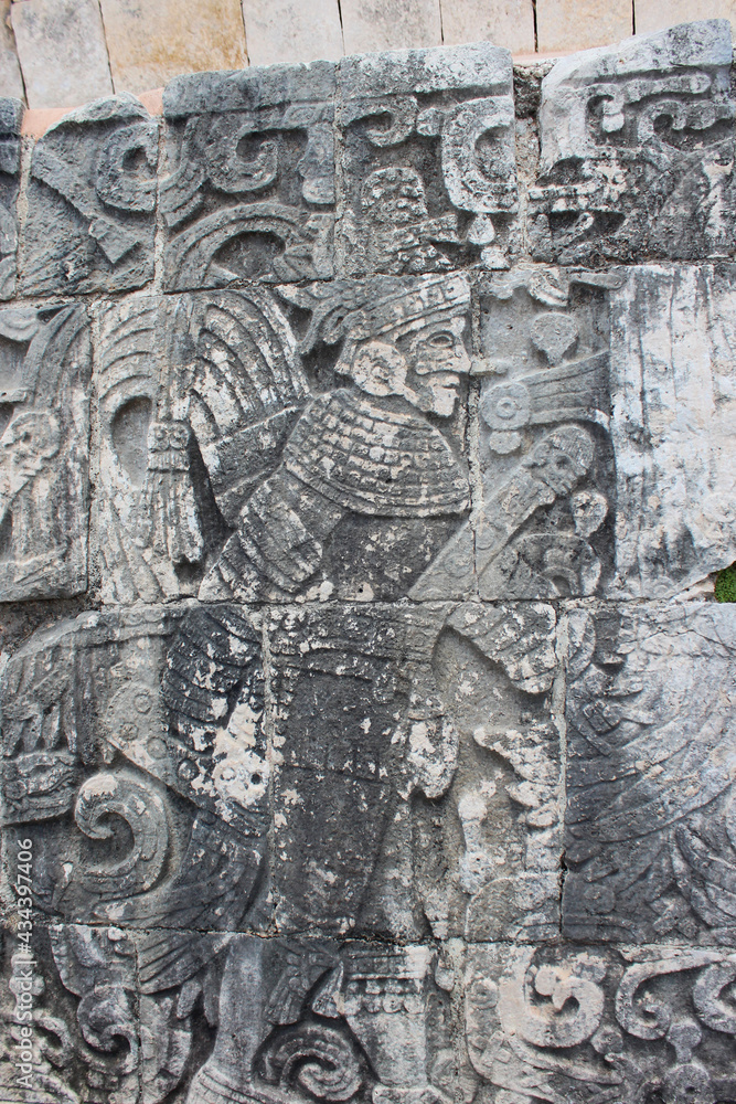 Detail of Mayan wall carving on the territory of Chichen Itza, Yucatan, Mexico. Ancient Mayan stone reliefs at Chichen Itza ruins, mexican archaeological site.
