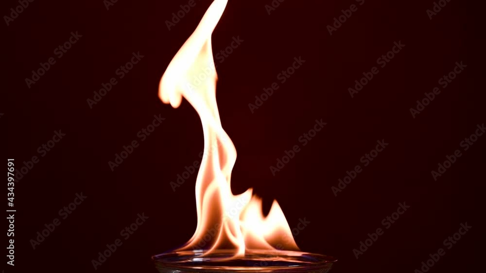 Beautiful bouncing flames on top of Martini glass filled with water Beautiful bouncing flames on top of Martini glass filled with water