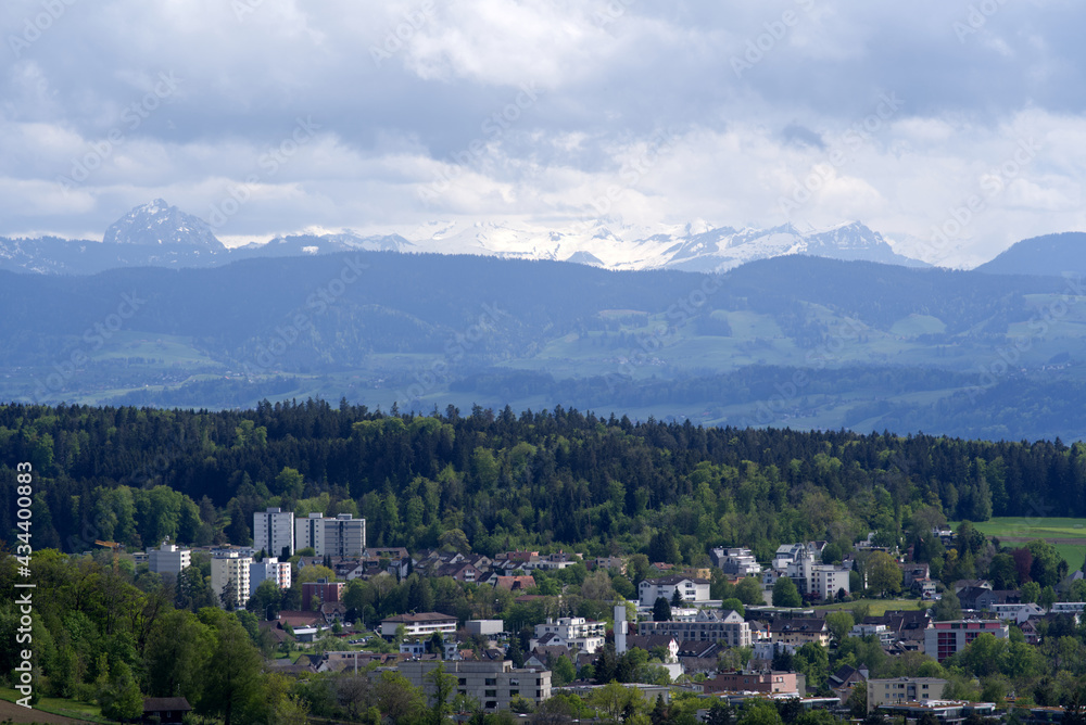 Landscape with mountains in the background seen from wooden lookout named Loorenkopfturm (Loorenkopf tower). Photo taken May 18th, 2021, Zurich, Switzerland.