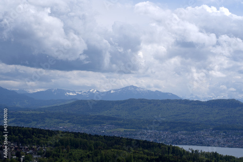Landscape with mountains in the background and part of Lake Zurich seen from wooden lookout named Loorenkopfturm (Loorenkopf tower). Photo taken May 18th, 2021, Zurich, Switzerland.