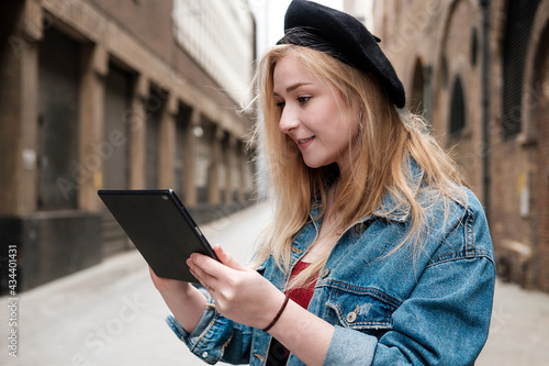 Young woman using a tablet outside.