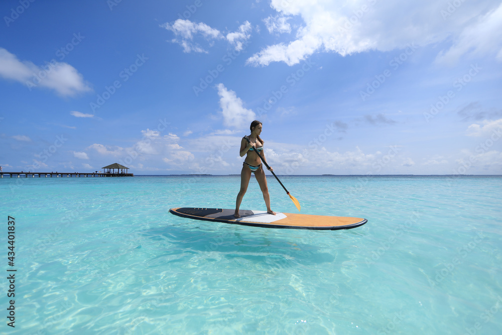 Fototapeta premium SUP surfing girl in Maldives