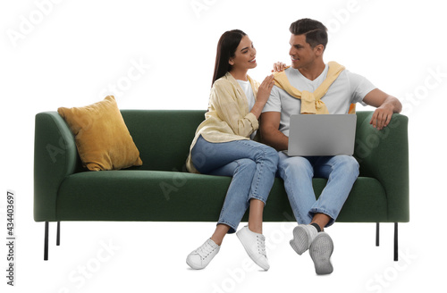 Happy couple resting on comfortable green sofa against white background