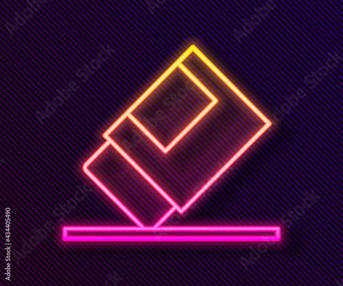 Glowing neon line Eraser or rubber icon isolated on black background. Vector