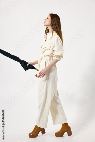 woman with umbrella in hands white suit modern style © SHOTPRIME STUDIO