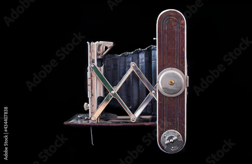 Antique folding camera isolated on the black background. Close shoot of the folding camera from 1930. 