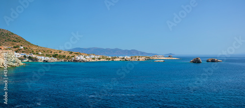 Greek fishing village with traditional whitewashed white houses on Milos island