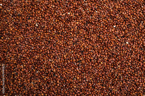 Heap of red quinoa as background  top view. Veggie seeds