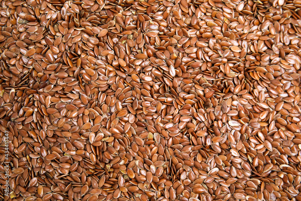 Heap of flax seeds as background, top view. Veggie food Heap of flax seeds as background, top view. Veggie food