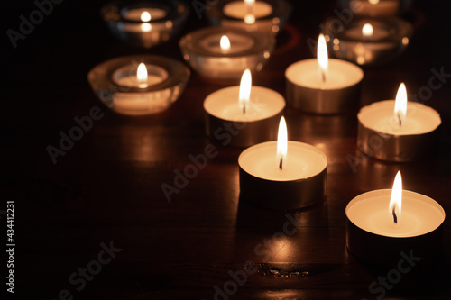 burning candles on wood table