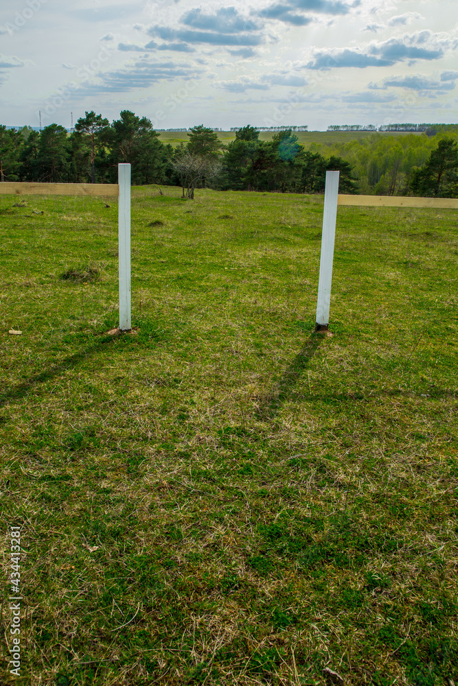 Fototapeta premium Lonely white gates in a field