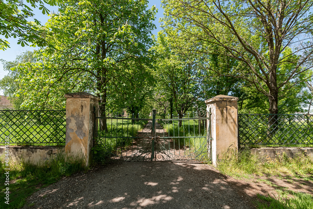Novo Milosevo, Serbia - May 04, 2021: Gate of Karaconji Castle in Novi Milosevo was built in 1857 and is one of the cultural monuments of great importance. Novo Milosevo, Serbia - May 04, 2021: Gate of Karaconji Castle in Novi Milosevo was built in 1857 and is one of the cultural monuments of great importance.