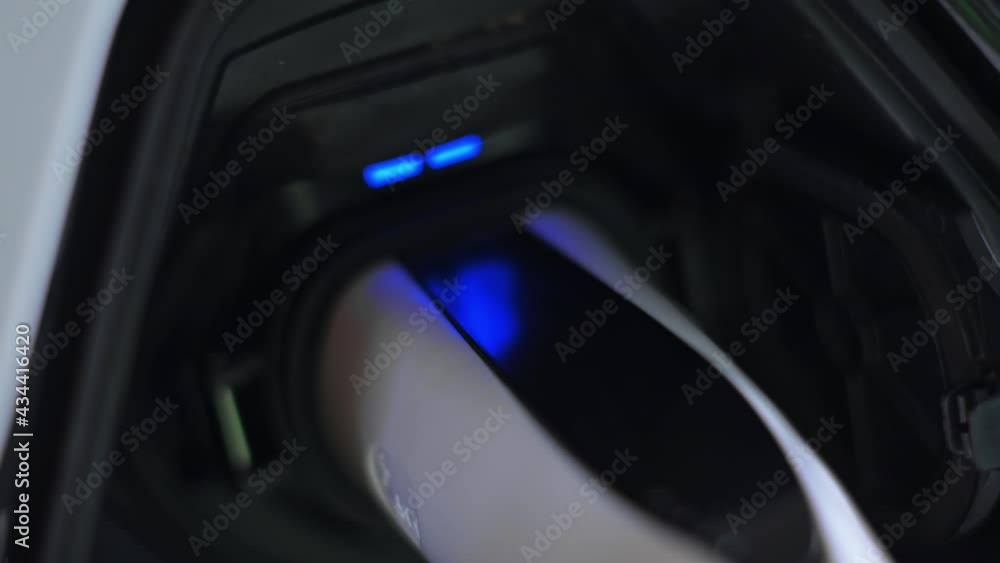 Plugged charger into an electric car, blue flickering light in the socket Plugged charger into an electric car, blue flickering light in the socket