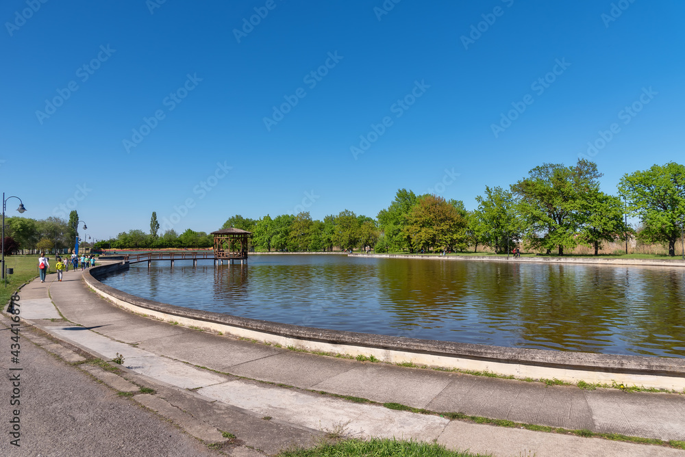 Kikinda, Serbia - May 04, 2021: The idylic rest zone - The Old lake (Staro Jezero: serbian) in the park of Kikinda town, Serbia Kikinda, Serbia - May 04, 2021: The idylic rest zone - The Old lake (Staro Jezero: serbian) in the park of Kikinda town, Serbia