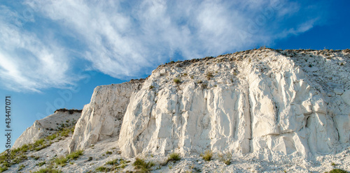 Ancient multimillion chalk mountains against the blue sky. Natural Chalk mining