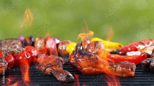 Chicken legs placed on grill grid with fire
