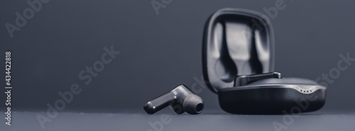 Blank wireless bluetooth earphones on black background