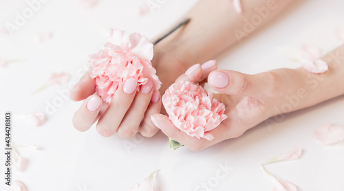 Banner manicure beautiful stylish trendy woman pink nails with flower on white background, top view