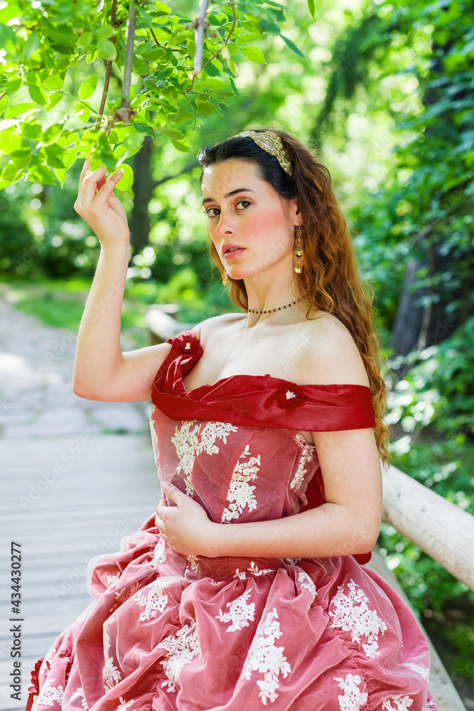 Victorian woman 19th century posing in red dress Victorian woman 19th century posing in red dress